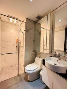 a bathroom with a toilet and a sink and a shower at Gem Apartment - VinCom D'Capitale Ha Noi in Hanoi