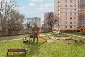 a park with a playground with a red slide at Długie Ogrody Spacious Apartment in the Gdańsk City Center by Renters in Gdańsk