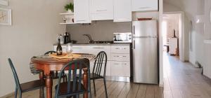 a kitchen with a table and a refrigerator at Nene's Home in Sanremo +33 photos