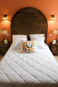 a large white bed with a pillow on it at Résidence La Dolce Vita in Ghisonaccia +58 photos