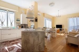 a large kitchen and living room with a dining room at Amazing view in Tellaro
