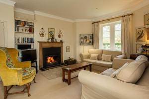 a living room with a couch and a fireplace at Melkington Lodge in Cornhill-on-tweed