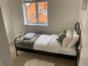 a bed in a room with a window at Brand New 3 Bedrooms Detached House in Westhoughton