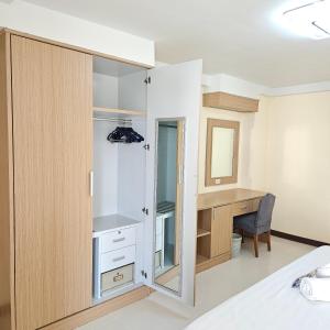 a bedroom with a closet and a desk at Omni Suites Serviced Apartment 1Bedroom in Bangkok