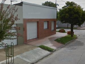a small brick building with a white garage at Alquiler por dia in San Carlos de Bolívar +7 photos