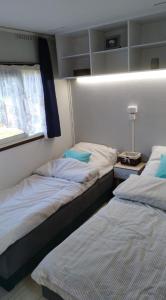 two beds sitting next to each other in a room at Mogielicki Zakątek in Jurków