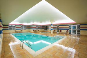 a large swimming pool in a building with a large roof at Residence Inn by Marriott Evansville East in Evansville