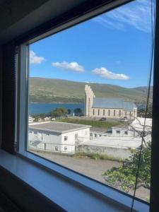 une fenêtre avec vue sur un grand bâtiment dans l'établissement Central by the Church *Family Villa, à Akureyri