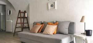 a living room with a gray couch with pillows at Nene's Home in Sanremo