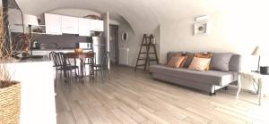 a living room with a couch and a kitchen at Nene's Home in Sanremo