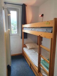 a room with two bunk beds and a window at Meije 15 - A2 - Appart vue degagee- 6 pers in Les Deux Alpes