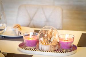 a tray with three candles and a glass dome on a table at MARBELLA BANUS SUITES - Banus Playa Rocio Direct Sea Access in Marbella