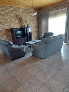a living room with two couches and a television at Dream lodging apartment in Vanderbijlpark