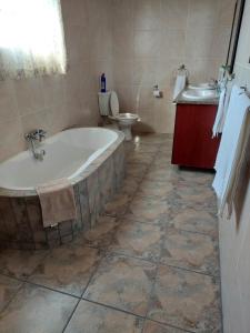 a bathroom with a tub and a toilet and a sink at Dream lodging apartment in Vanderbijlpark