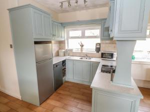 a kitchen with white cabinets and a sink at Sheemore View in Kilclare