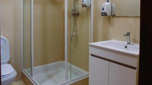 een badkamer met een douche, een wastafel en een toilet bij Cova de Lobo in Batalha