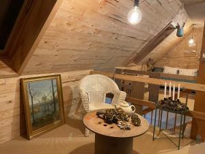 a room with a table and a chair and a table with candles at Nygaard B&B in Nørre Nebel