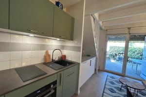 a kitchen with a sink and a counter top at The beachside coquette in Frontignan