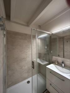 a bathroom with a shower and a sink at The beachside coquette in Frontignan