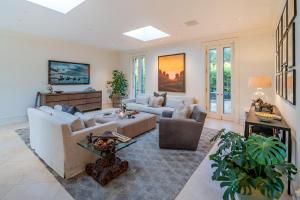 a living room with a couch and a table at Lavish Montecito Home with Hot Tub, Patio and Gardens! in Montecito