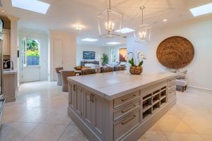 a kitchen with a large island and a living room at Lavish Montecito Home with Hot Tub, Patio and Gardens! in Montecito
