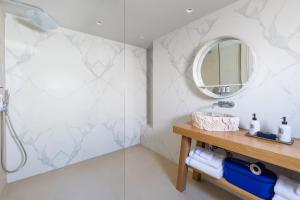 a bathroom with a sink and a mirror at Nammos Hotel Mykonos in Psarou