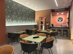 a restaurant with tables and chairs and a counter at House Room Civico 56 in Crotone