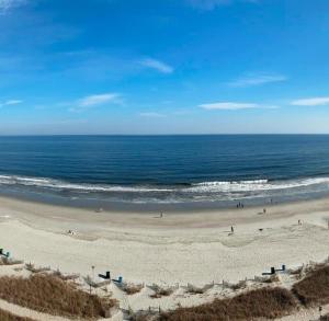 a view of a beach with people in the ocean at Blue Palmetto in Myrtle Beach