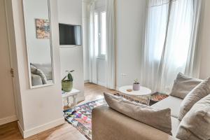 a living room with a couch and a tv at Old Town Apartment in Corfu Town