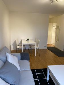 een woonkamer met een bank en een tafel met stoelen bij Great 1 bedroom flat on Lidingo in Kottla