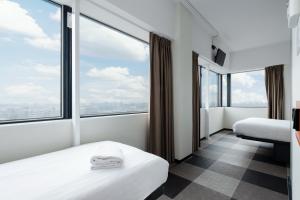 a hotel room with two beds and a large window at easyHotel Amsterdam Zaandam in Zaandam