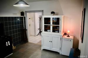 a bathroom with a white cabinet with a candle on a table at Loggia Motovun in Motovun