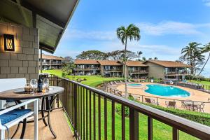 a balcony with a view of a pool and resort at Polynesian Shores 205 in Kahana