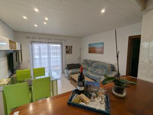 a living room with a table with a bottle of wine at La Casa del Sol, Abades in Abades