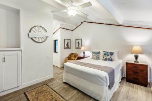 a bedroom with a bed and a clock on the wall at Polynesian Shores 205 in Kahana