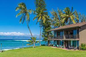 a house on the beach with palm trees at Polynesian Shores 205 in Kahana
