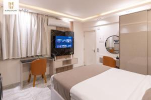 a hotel room with a bed and a television at Homztality Elbatal Mohandeseen in Cairo