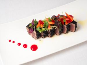 a white plate with a dish of food on it at Albatros Beach Hotel in Letojanni