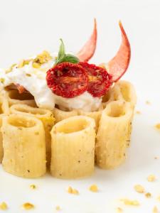 a white plate with a dessert with a strawberry on top at Albatros Beach Hotel in Letojanni