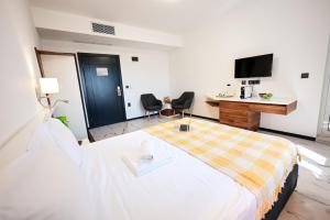 a hotel room with a bed and a tv at RUBO Hotel in Shumen