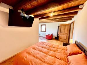 a bedroom with a bed and a flat screen tv at Villa Saten in Pavia dʼUdine