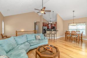 a living room with a blue couch and a table at Spacious 4 Bedroom House-2 Blocks From the Ocean-2185 Sanibel Court! in Myrtle Beach