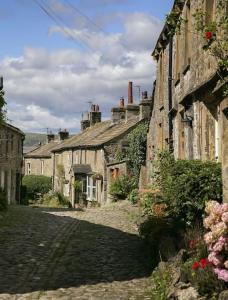 a group of stone houses on a cobblestone street at White Cottage deluxe 2 bedroom apartment in Grassington