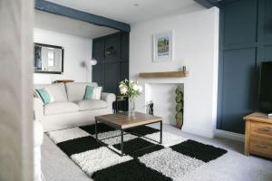 a living room with a white couch and a table at White Cottage deluxe 2 bedroom apartment in Grassington