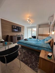 a bedroom with a bed and a tv on a wall at Villa Anthony in Rovinj