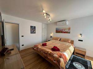 a bedroom with a large bed with red roses on it at Villa Anthony in Rovinj