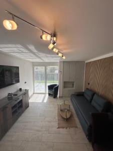 a living room with a black couch and a table at Villa Anthony in Rovinj