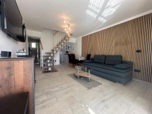 a living room with a blue couch and a table at Villa Anthony in Rovinj