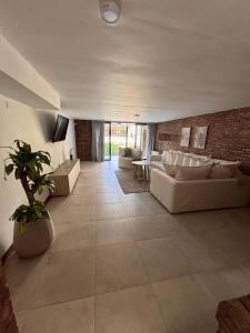 a large living room with couches and a brick wall at CASA ALMA LUXURY HOME in Mendoza