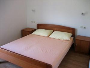 a bedroom with a bed with two white pillows at Apartment Ante in Račišće